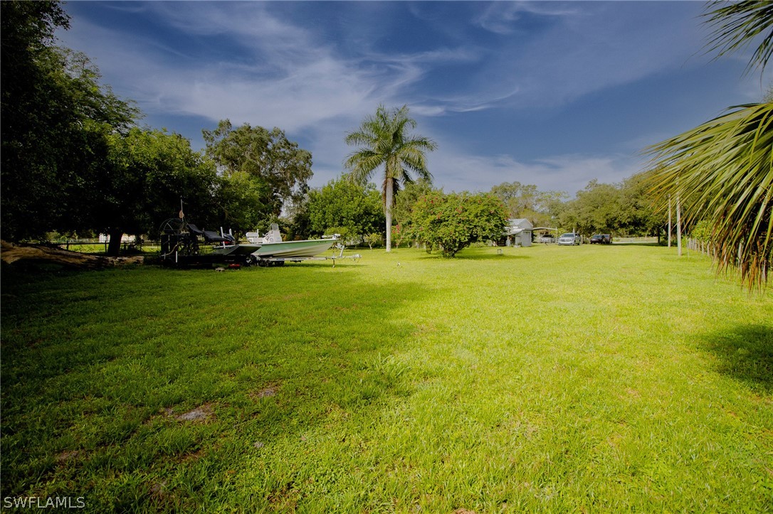 2671 Packinghouse Road Alva, FL 33920 - Photo 9 of 24 a view of a swimming pool and a yard