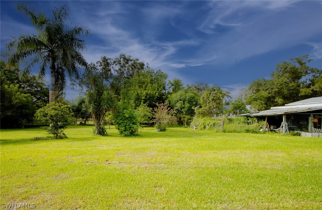 2671 Packinghouse Road Alva, FL 33920 - Photo 10 of 24 a view of a swimming pool with an outdoor space and seating area