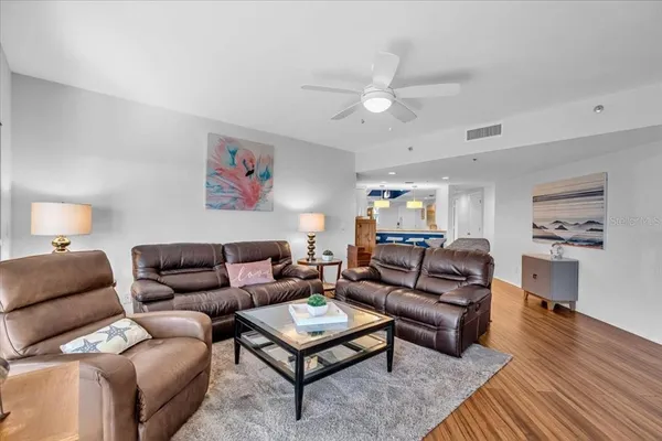 a living room with furniture a rug and a chandelier