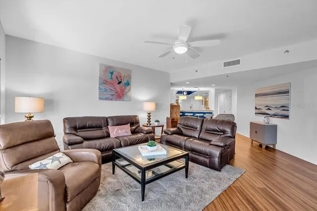 a living room with furniture a rug and a chandelier