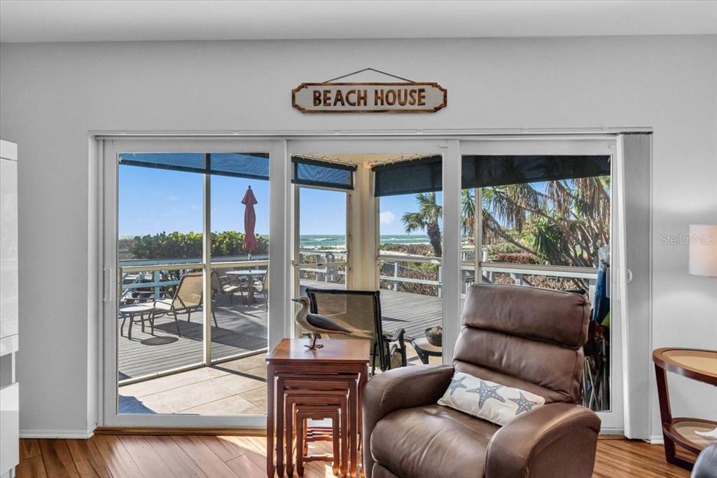 5621 Gulf Of Mexico Drive, Unit 102 Longboat Key, FL 34228 - Photo 13 of 22 a living room with furniture and a large window