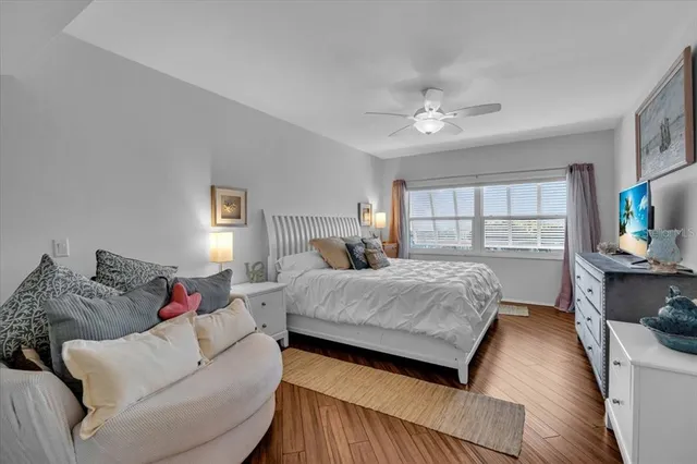 a bed room with a bed couch tv and a window