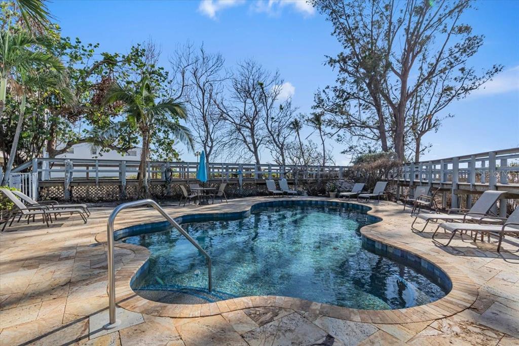 5621 Gulf Of Mexico Drive, Unit 102 Longboat Key, FL 34228 - Photo 20 of 22 a view of a swimming pool with a patio