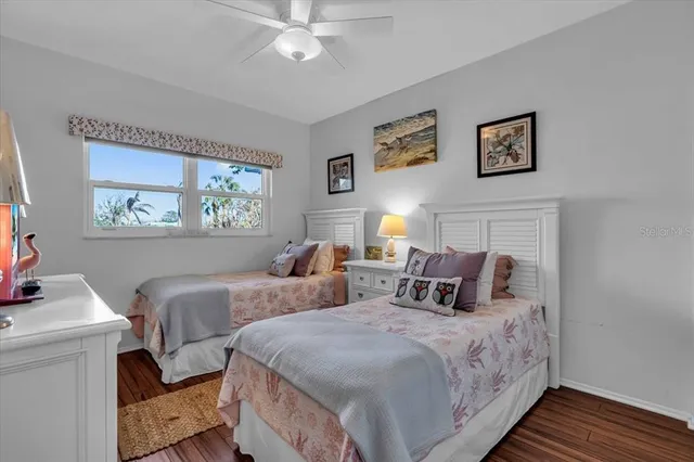 a bedroom with two beds and a chandelier