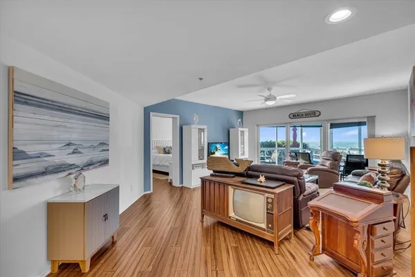 a view of a kitchen counter top space with stainless steel appliances wooden floor and a window