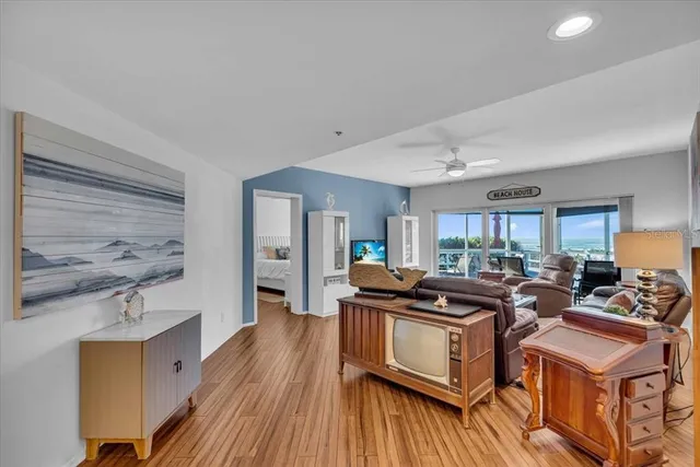 a view of a kitchen counter top space with stainless steel appliances wooden floor and a window