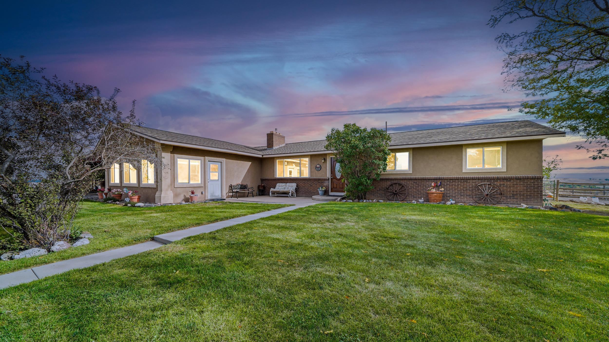 20786 Iris Road Austin, CO 81410 - Photo 3 of 38 a front view of a house with a yard and outdoor seating