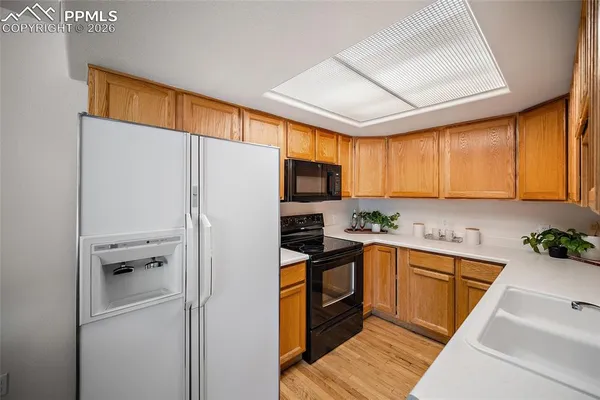a kitchen with a refrigerator a sink and cabinets