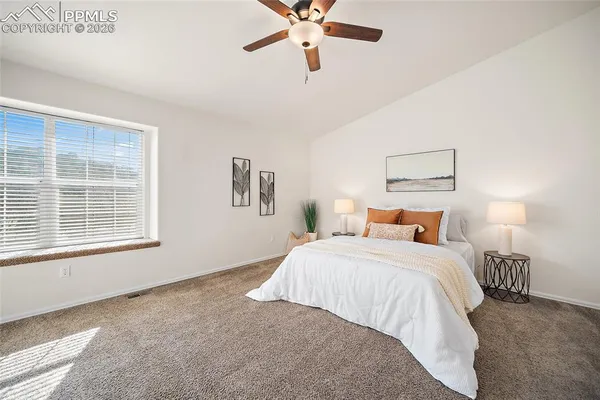 a bedroom with a bed and window