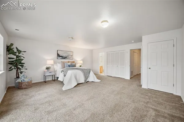 a bed room with furniture and a potted plant