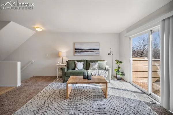 a living room with furniture and a rug