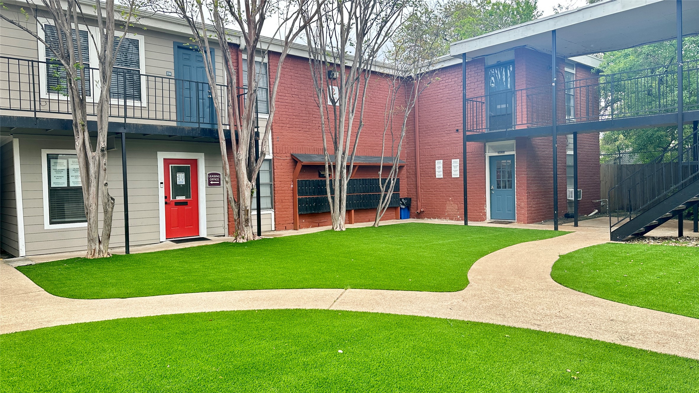 5426 Menchaca Road, Unit 125 Austin, TX 78745 - Photo 1 of 8 Central courtyard featuring artificial turf and concrete pathways