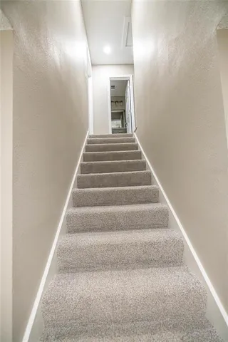 a spacious bathroom with a double vanity sink and a mirror