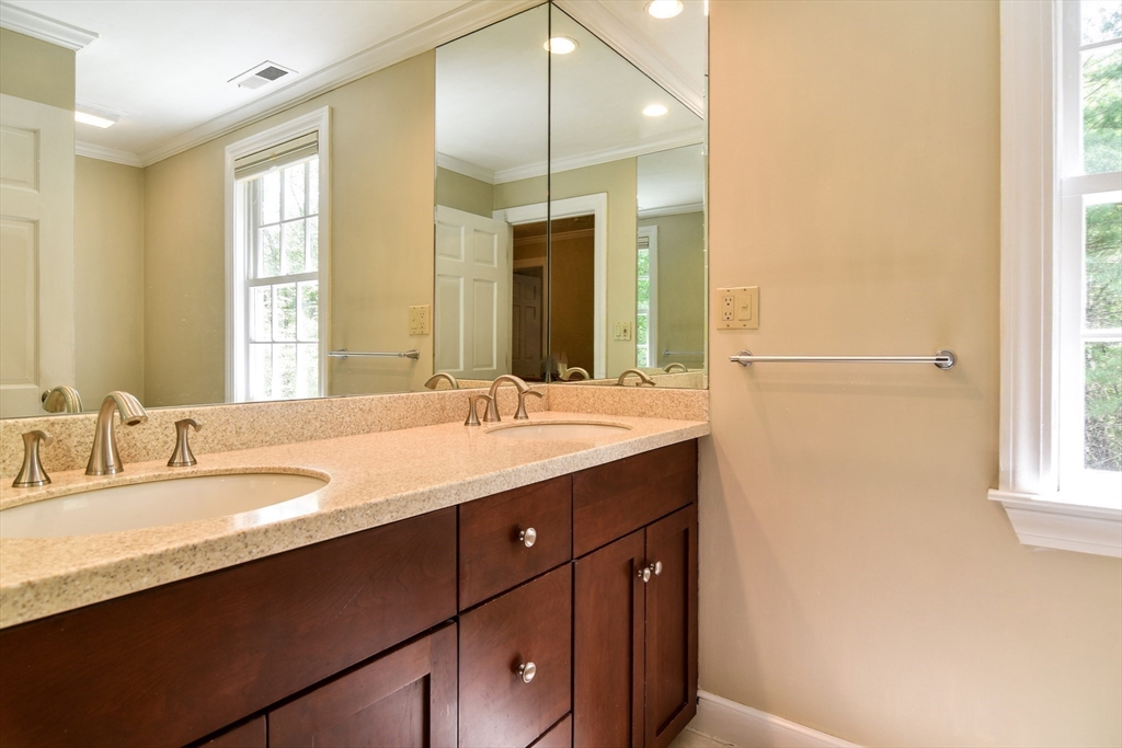 114 Hunters Ridge Road Concord, MA 01742 - Photo 28 of 38 a bathroom with a double vanity sink and a mirror