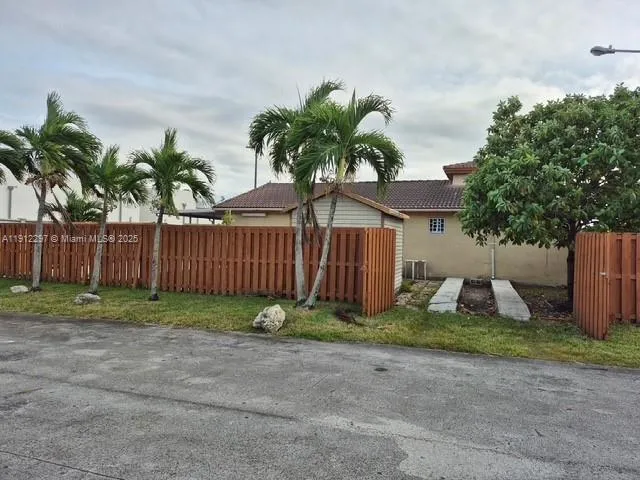 a front view of a house with garden and plants