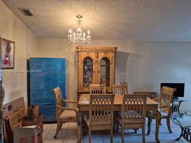 a view of a dining room with furniture and chandelier