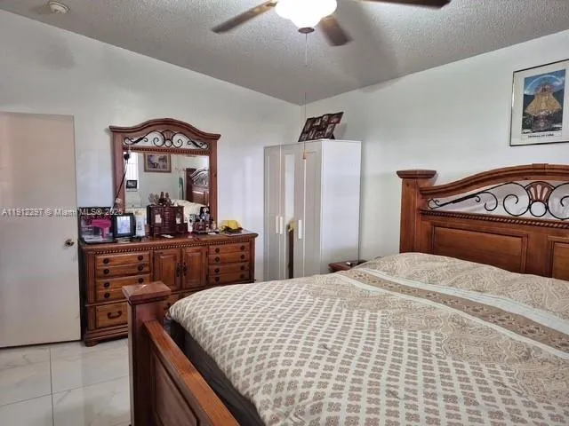a bedroom with a bed and a mirror on dresser