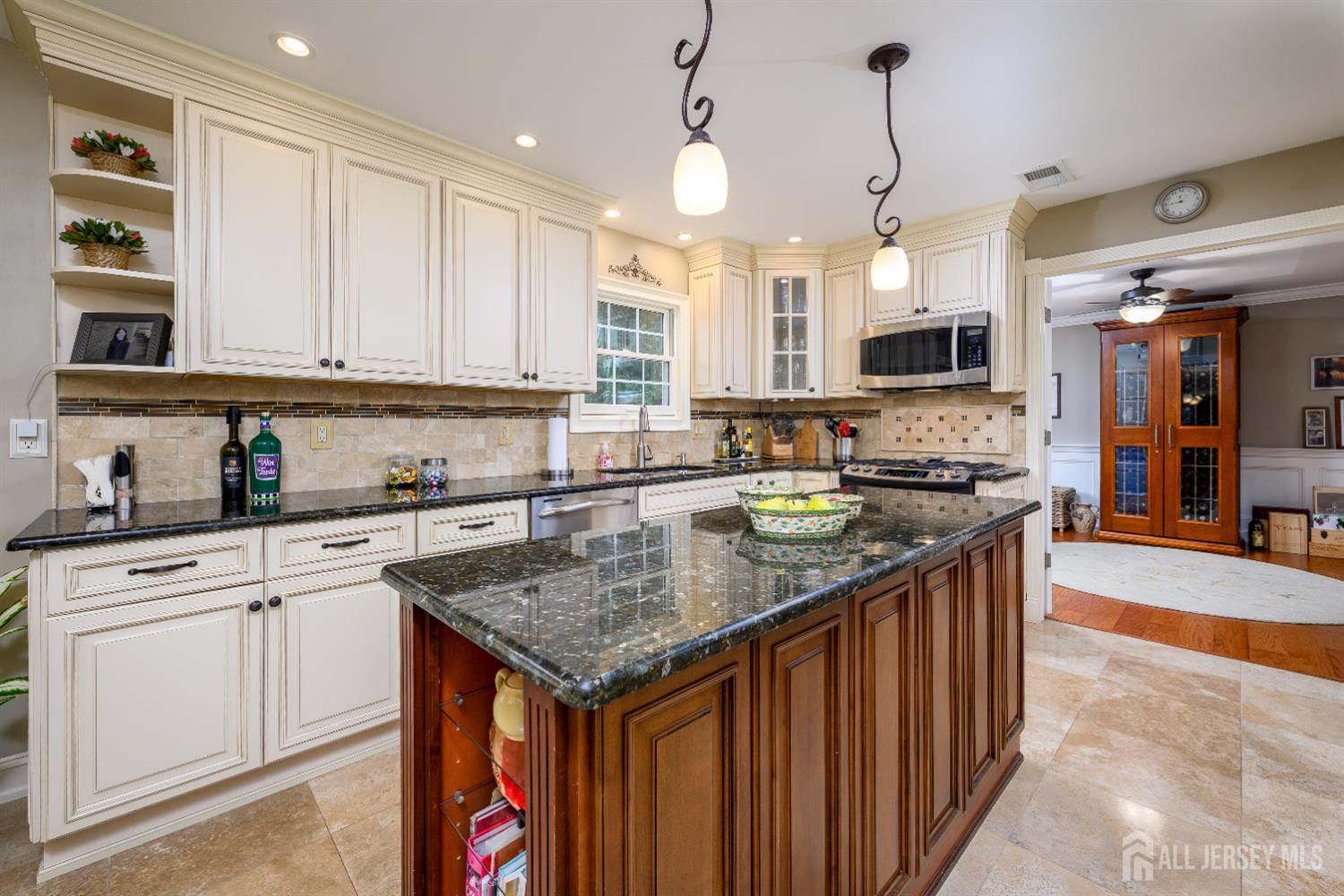 7 Manor Court Old Bridge, NJ 08857 - Photo 15 of 46 a kitchen with stainless steel appliances granite countertop a sink stove and cabinets