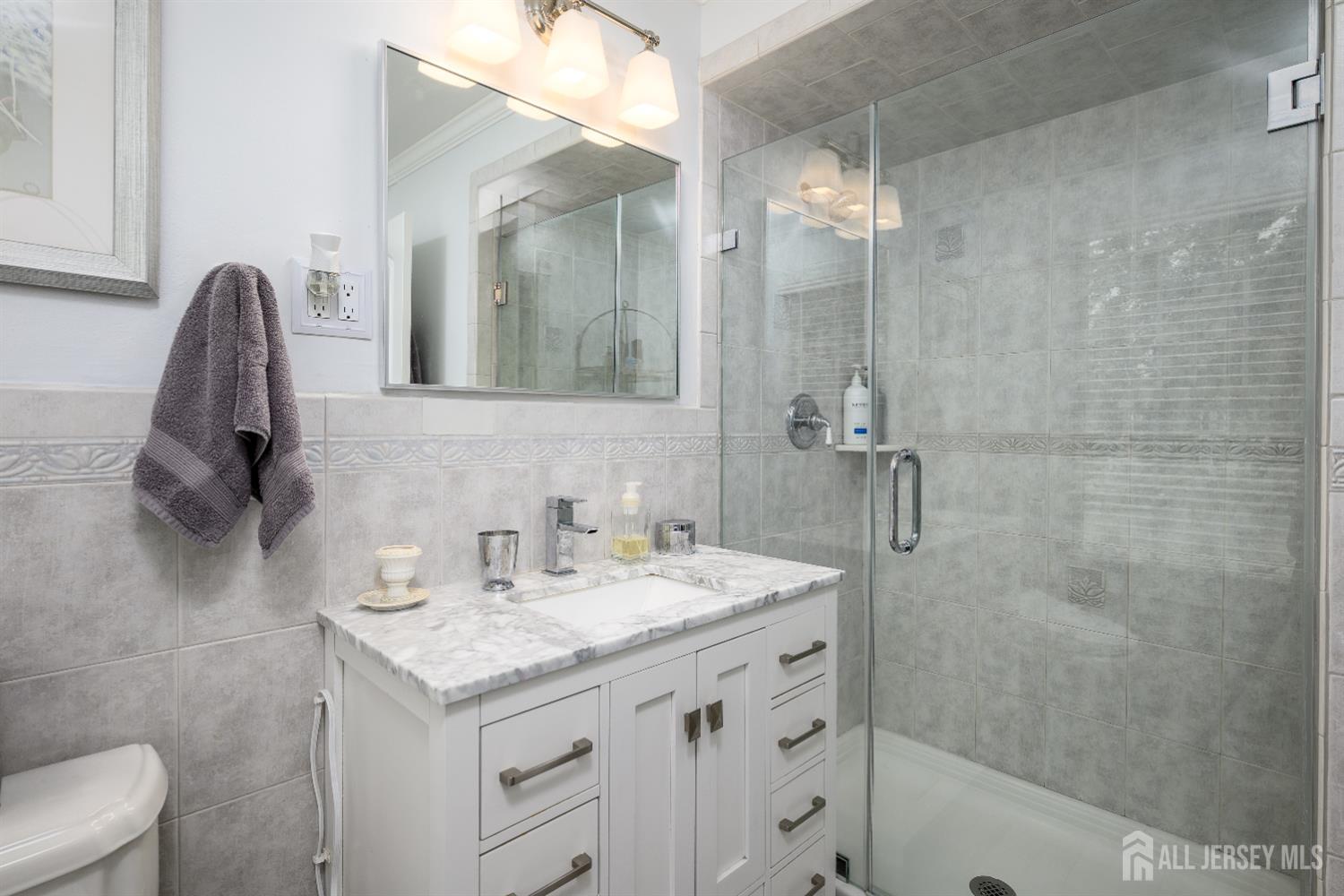 7 Manor Court Old Bridge, NJ 08857 - Photo 25 of 46 a bathroom with a sink and a mirror