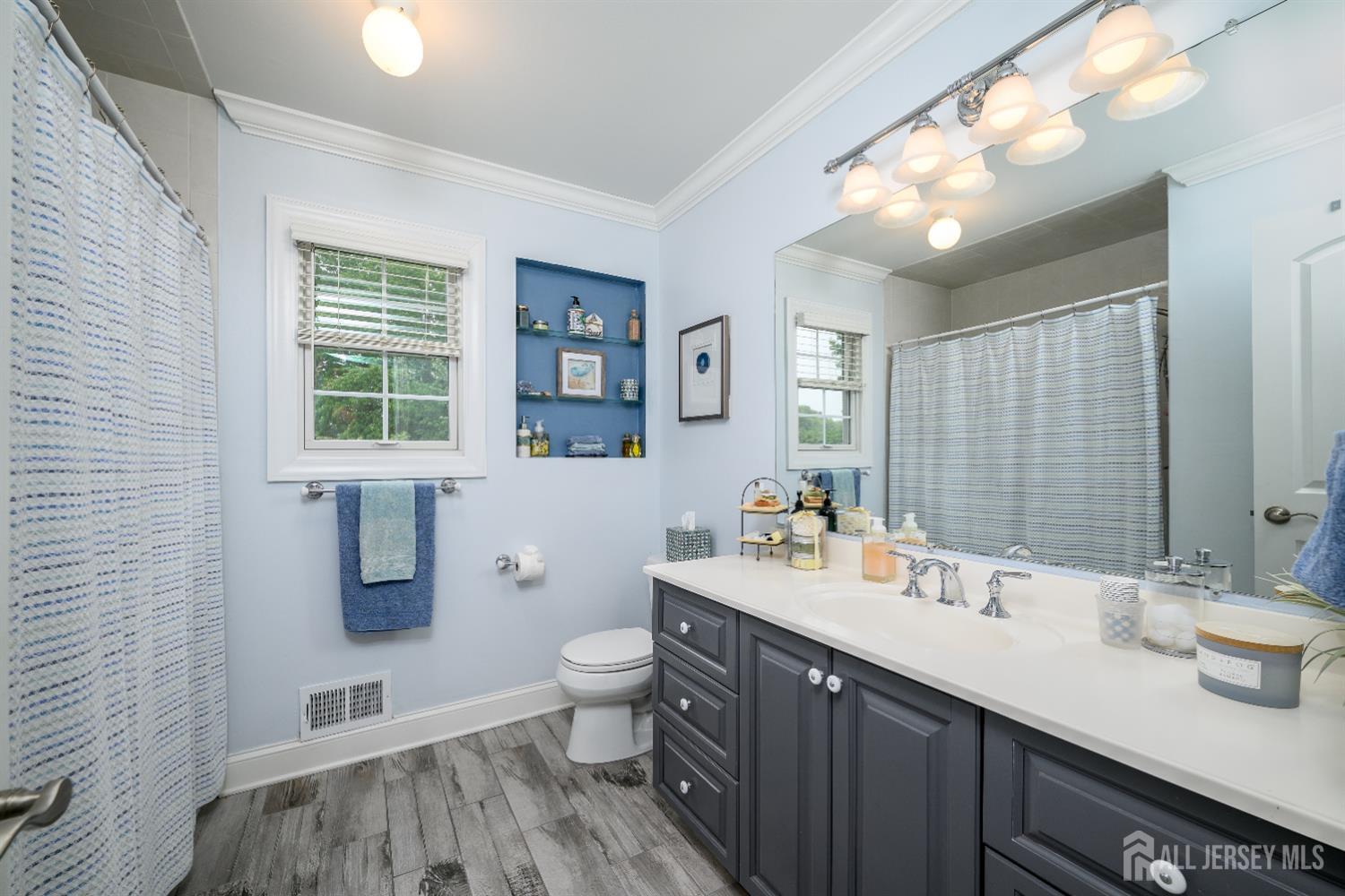 7 Manor Court Old Bridge, NJ 08857 - Photo 33 of 46 a bathroom with a sink a toilet and a mirror