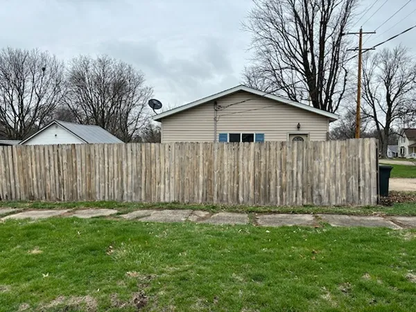a front view of a house with a fence