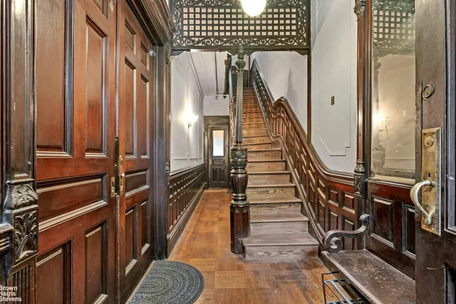 a view of stairs and hall with wooden floor