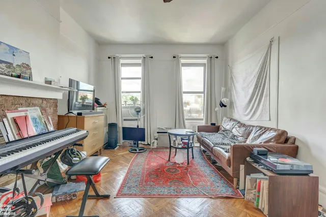 a living room with furniture and a book shelf