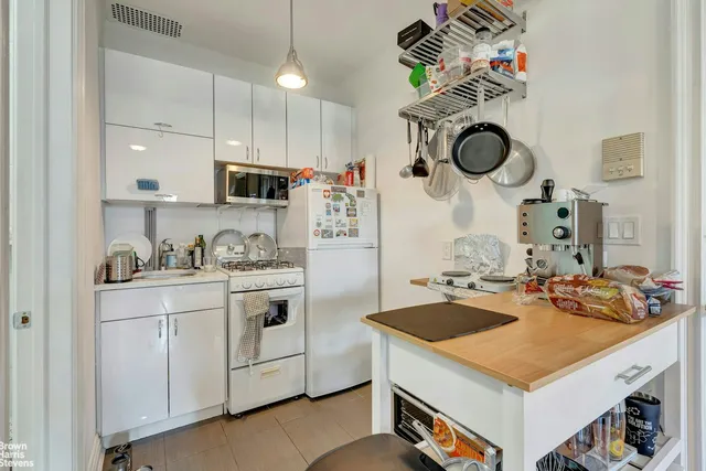 a kitchen with a sink dishwasher a stove and a fireplace with wooden floor