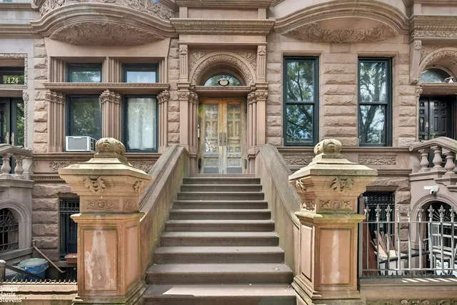 a front view of a house with a fountain