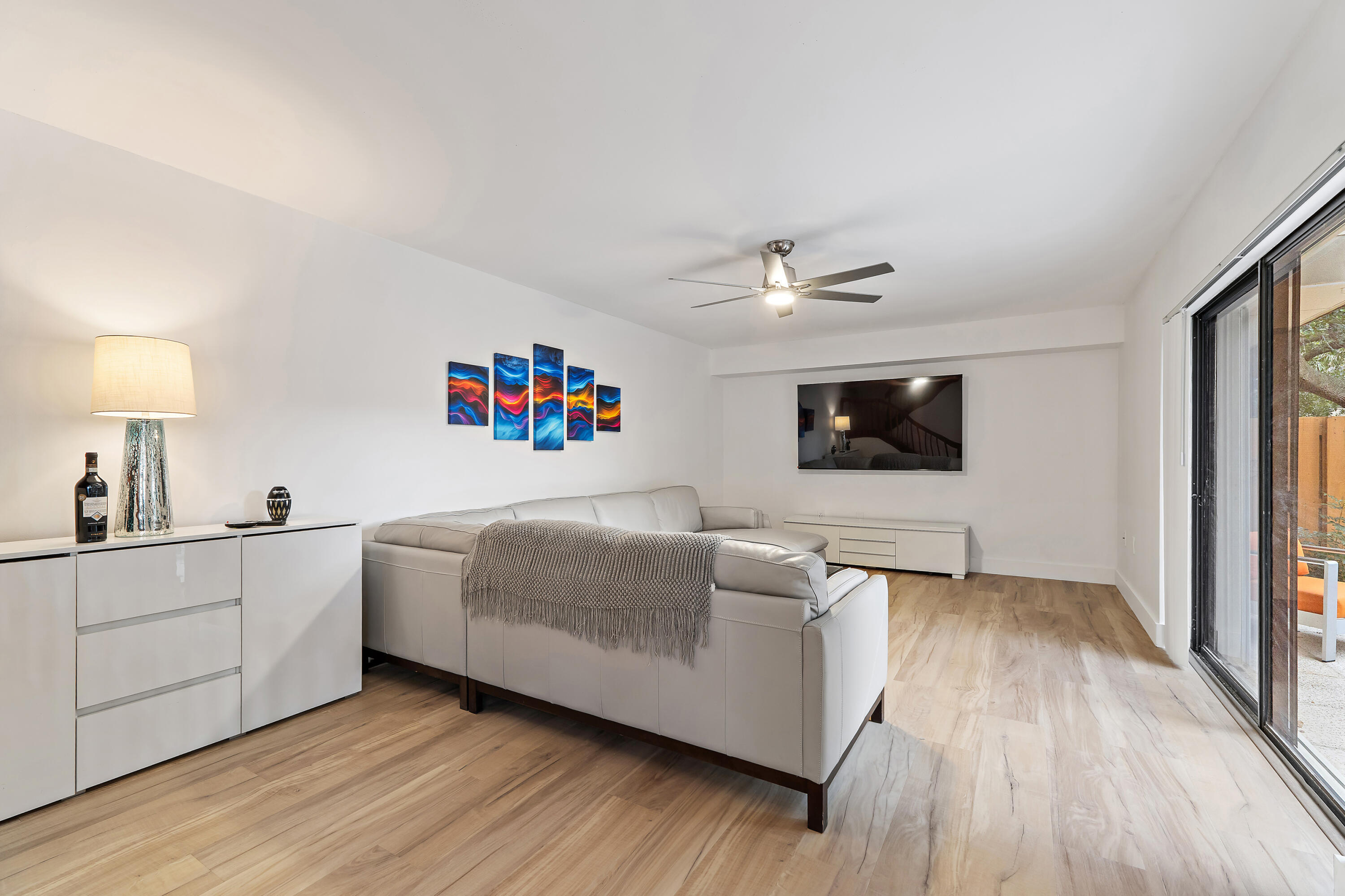 3052 30th Court Jupiter, FL 33477 - Photo 12 of 45 a living room with furniture and a flat screen tv