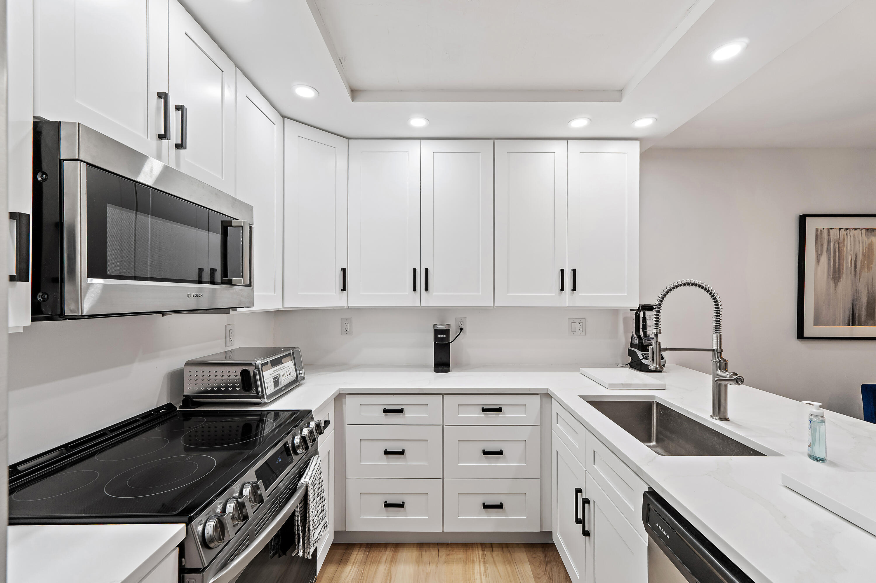 3052 30th Court Jupiter, FL 33477 - Photo 22 of 45 a kitchen with granite countertop a sink stainless steel appliances and cabinets