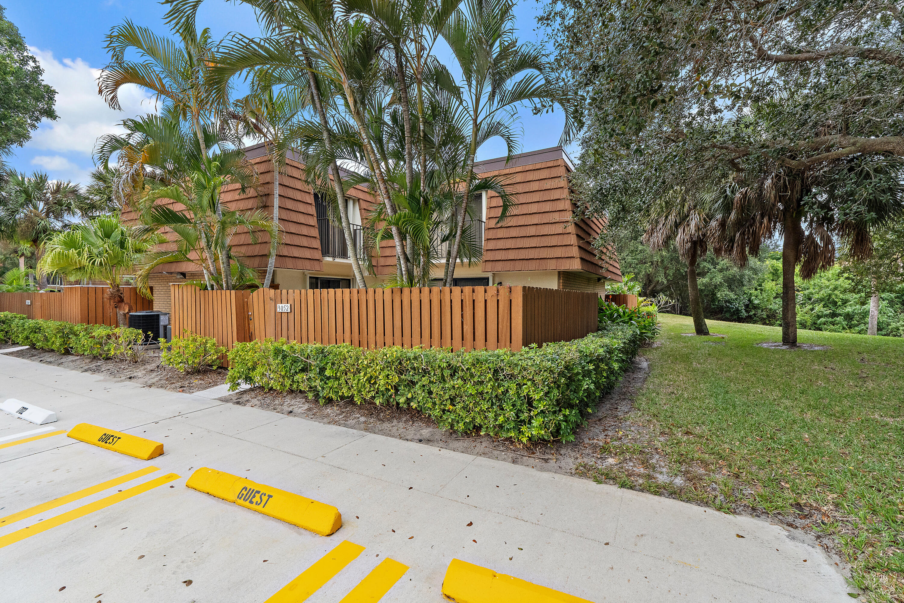 3052 30th Court Jupiter, FL 33477 - Photo 4 of 45 a view of a backyard with swimming pool