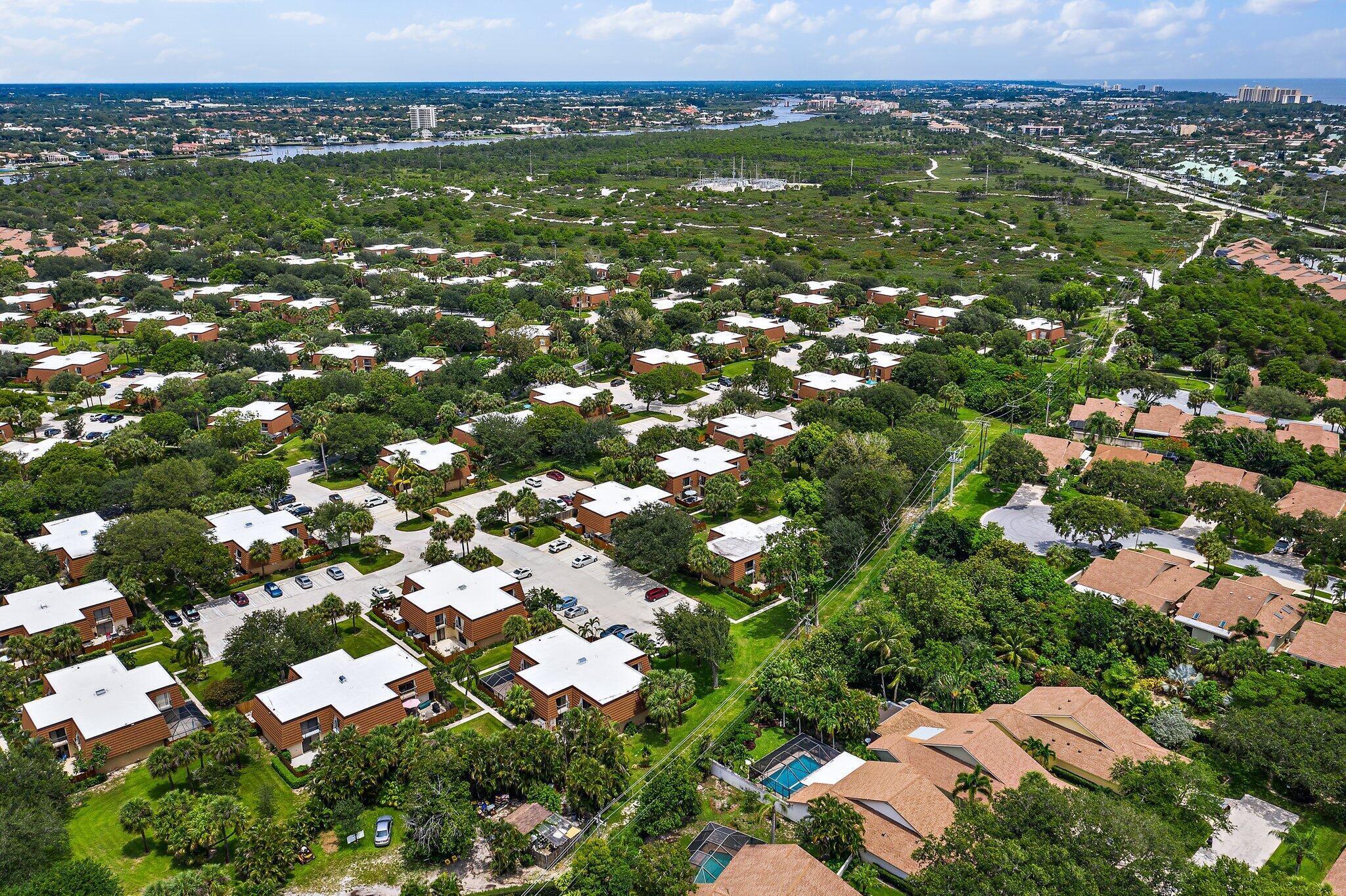 3052 30th Court Jupiter, FL 33477 - Photo 41 of 45 an aerial view of residential houses with outdoor space and trees