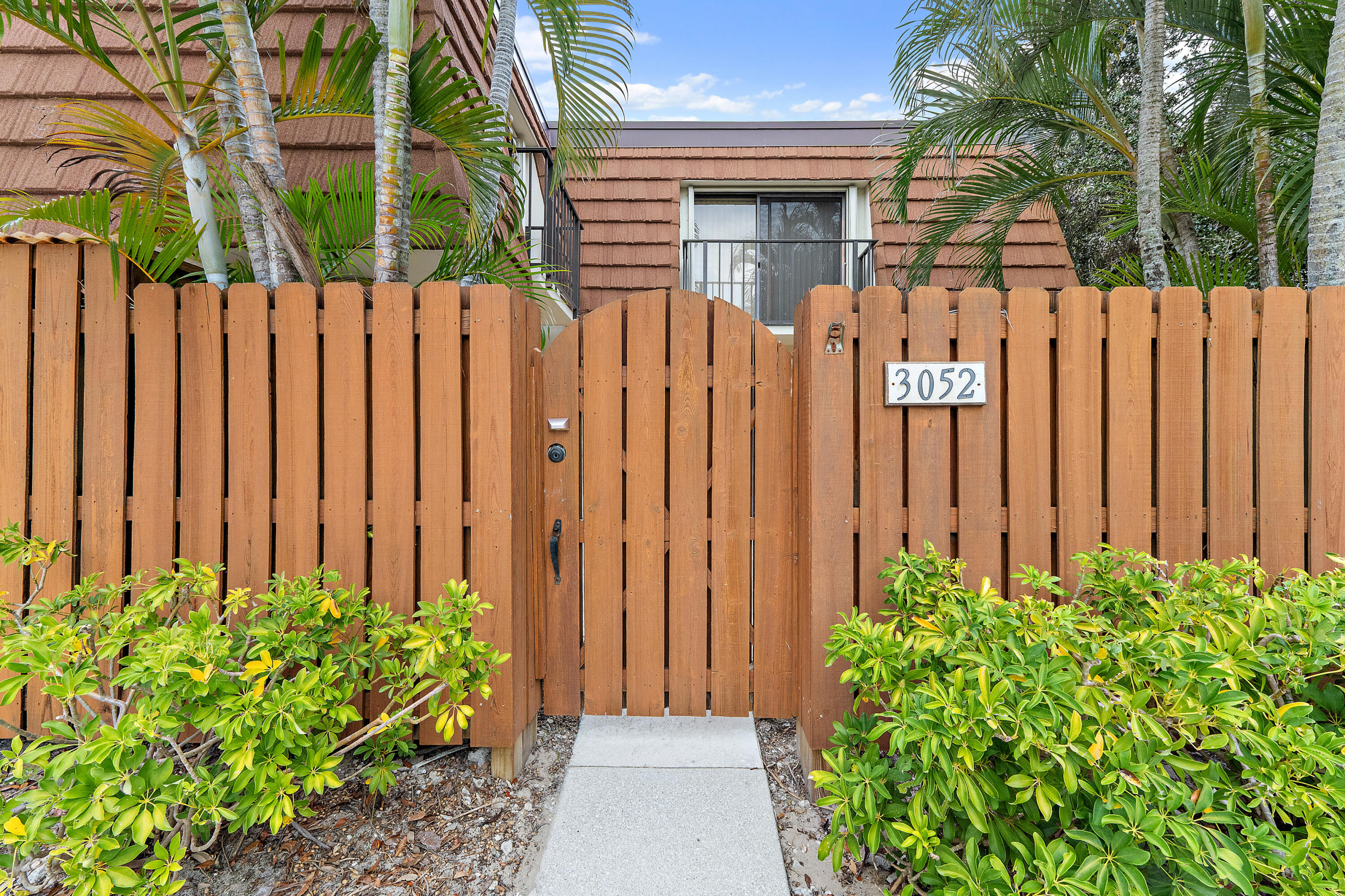 3052 30th Court Jupiter, FL 33477 - Photo 6 of 45 a view of a pathway with a flower plants