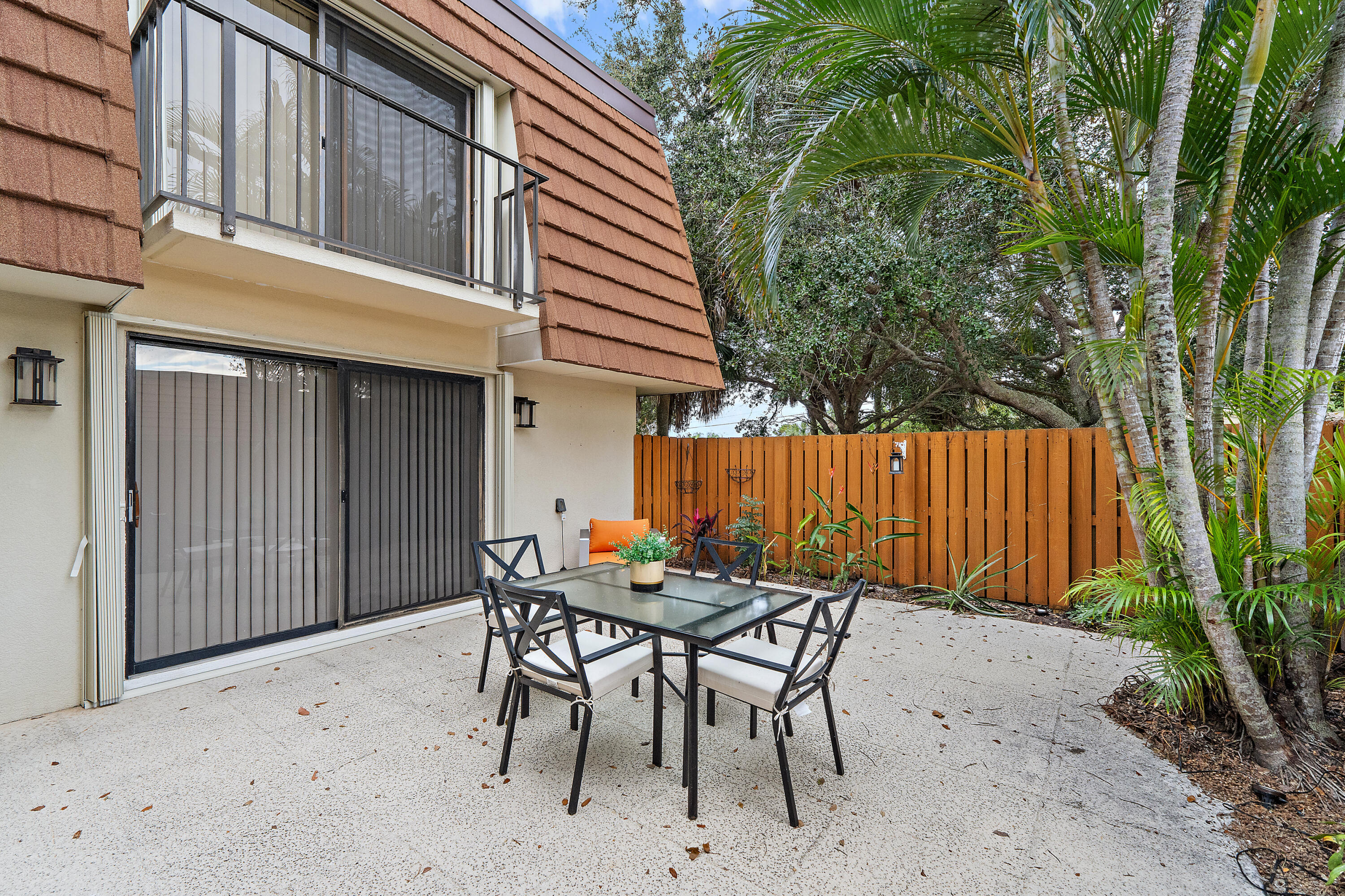 3052 30th Court Jupiter, FL 33477 - Photo 7 of 45 a backyard of a house with table and chairs