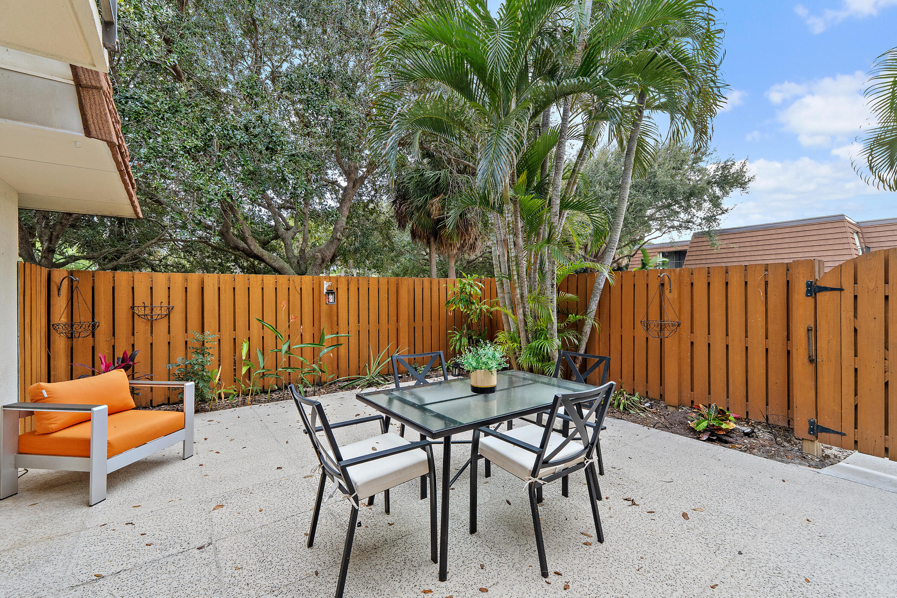 3052 30th Court Jupiter, FL 33477 - Photo 8 of 45 a backyard of a house with table and chairs