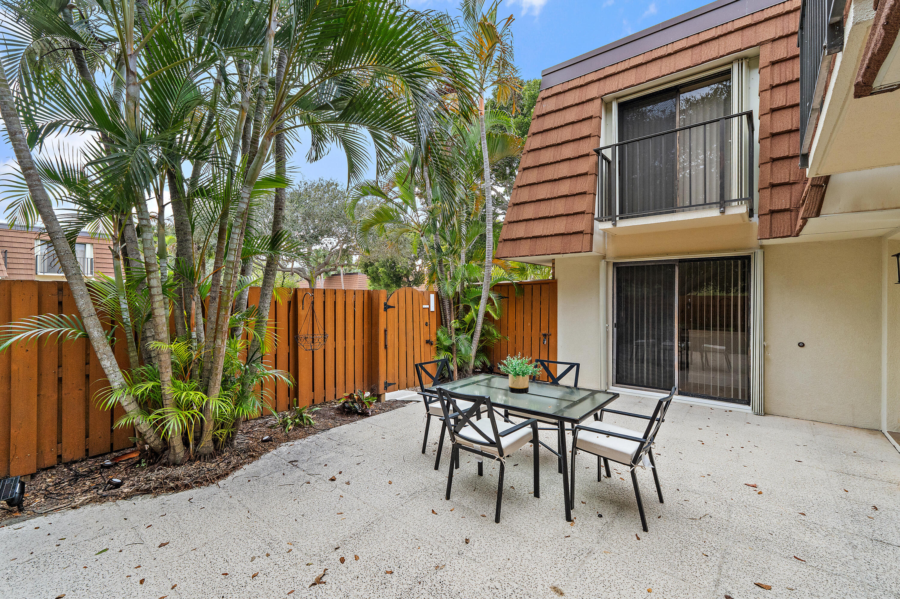 3052 30th Court Jupiter, FL 33477 - Photo 9 of 45 a view of a backyard with a patio and outdoor seating