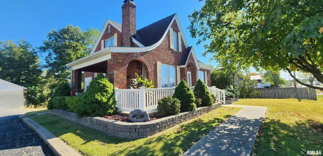 a front view of house with outdoor space and swimming pool