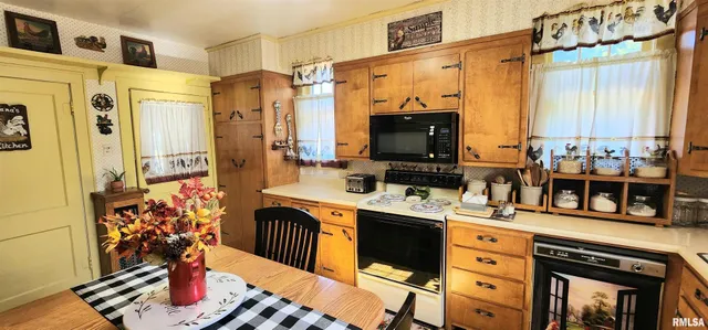 a kitchen that has a lot of cabinets a sink and a stove
