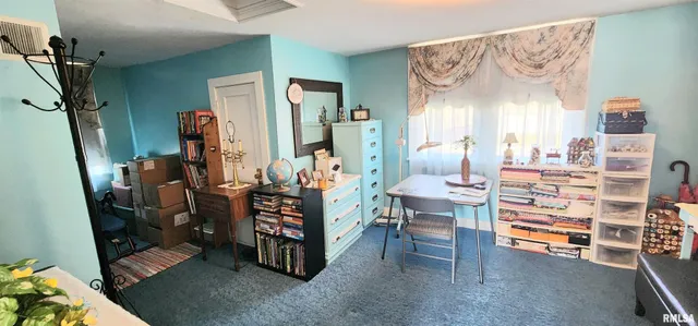a room with lots of wooden furniture and a window