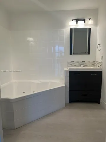 a bathroom with a bathtub and a sink