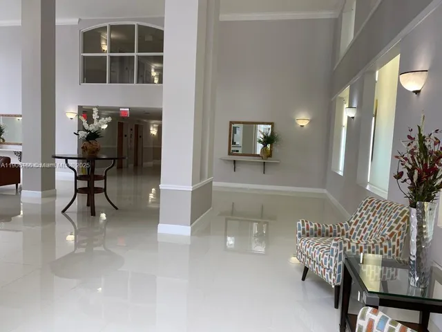 a lobby with furniture and rug