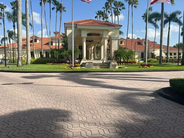 a view of a building and a yard in a back