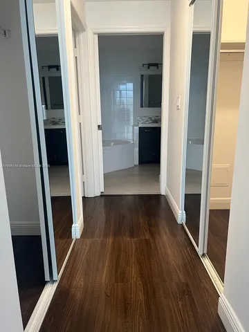 a view of gallery with wooden floor