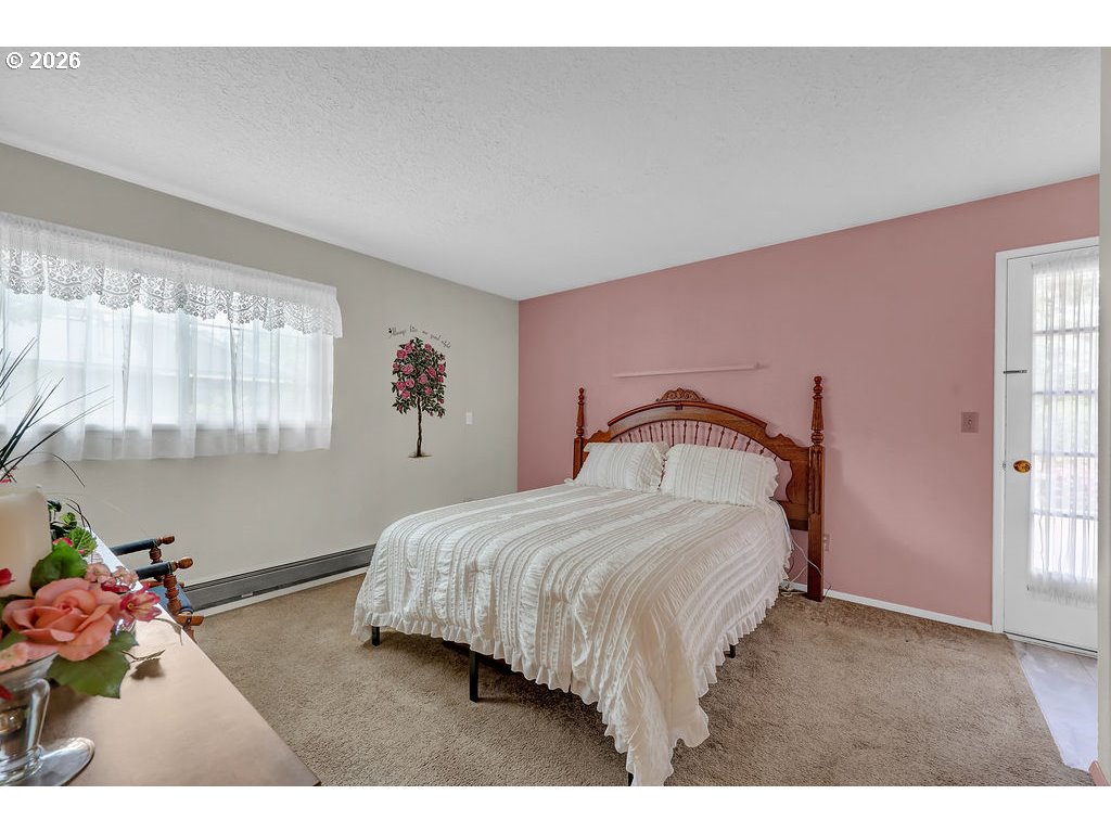 1415 20th Street Florence, OR 97439 - Photo 18 of 40 a bedroom with a bed and a window