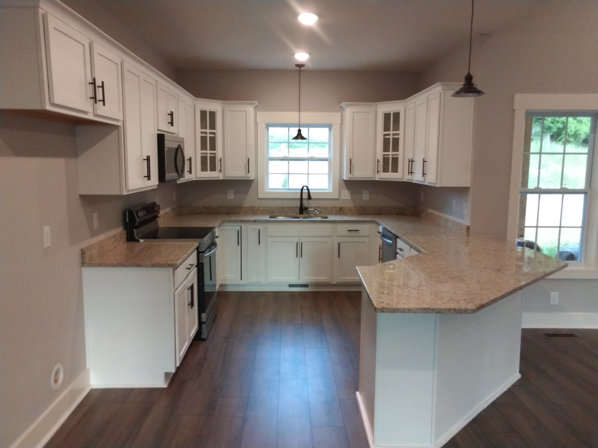 2006 McMahan Hollow Road Pleasant View, TN 37146 - Photo 3 of 20 a kitchen with granite countertop a sink a window stainless steel appliances and cabinets