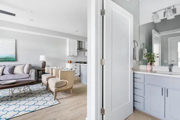 a living room with furniture a rug and a mirror