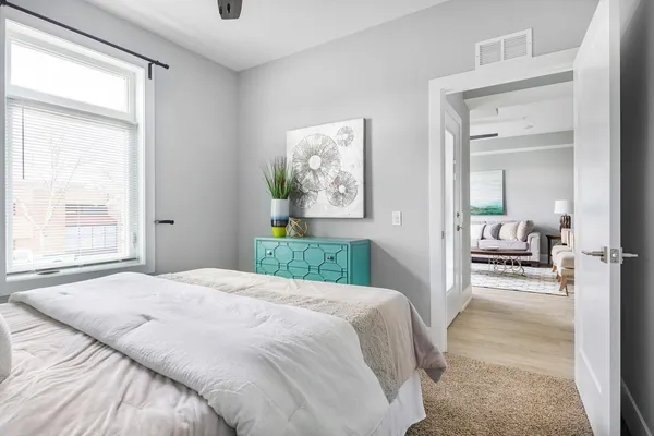 a bedroom with a bed and a large window