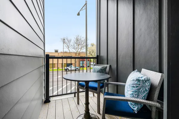 a view of a balcony with furniture and wooden floor