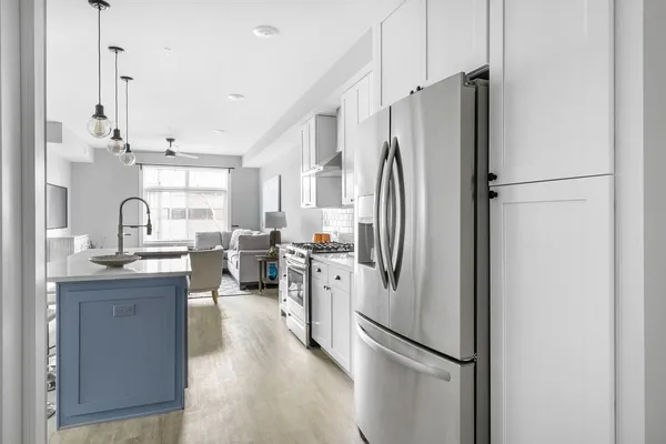 a kitchen with stainless steel appliances a refrigerator and a sink